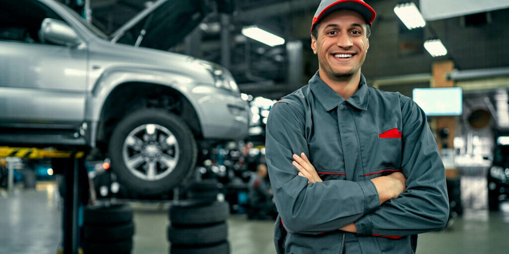 car service technician smiling with arms folded